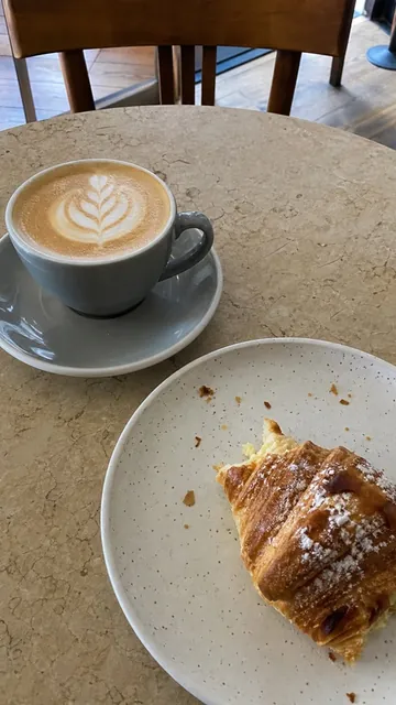 Her answer: a flat white and a croissant, with her selfie in the corner.